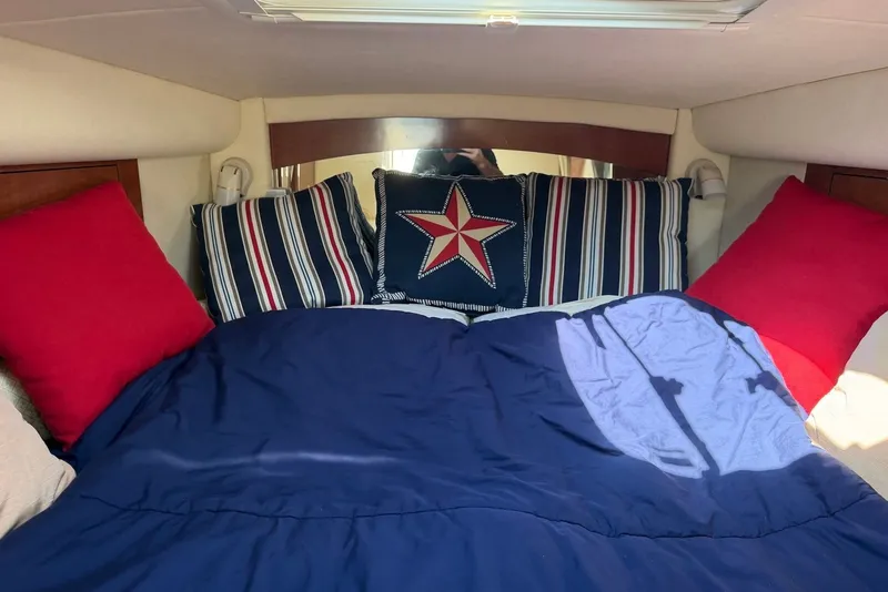 Slide: The Image of Cozy cabin interior of 2004 Sea Ray 340 Sundancer with nautical-themed bedding. - 30