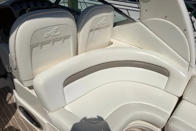 Slide: The Image of 2004 Sea Ray 340 Sundancer boat interior with white leather seating and dashboard. - 6