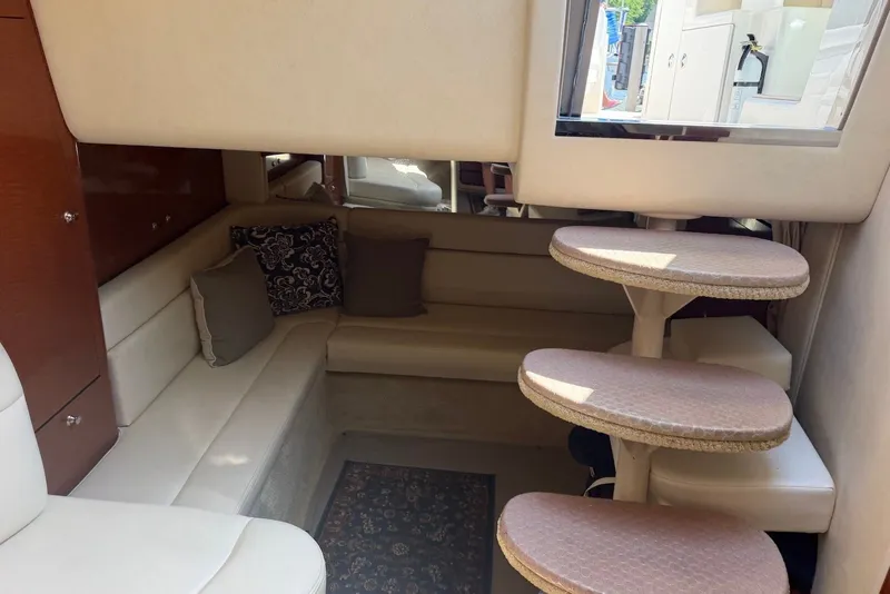 Slide: The Image of Interior of 2004 Sea Ray 340 Sundancer with cozy seating and elegant decor. - 26