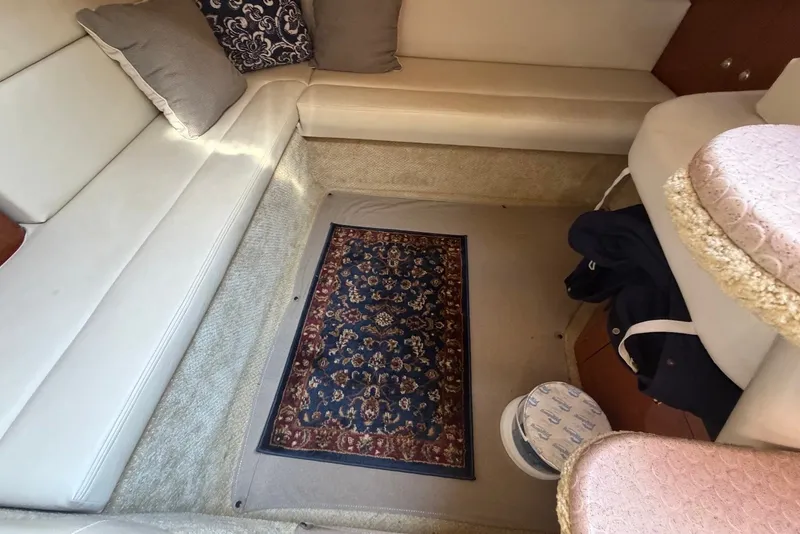 Slide: The Image of Interior of 2004 Sea Ray 340 Sundancer with beige seating and decorative rug. - 22