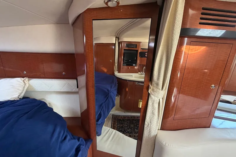 Slide: The Image of Interior of 2004 Sea Ray 340 Sundancer yacht with wood paneling and mirror. - 25