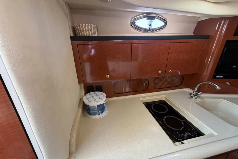 Slide: The Image of Luxurious 2004 Sea Ray 340 Sundancer yacht kitchen with sleek cabinetry and modern appliances. - 12