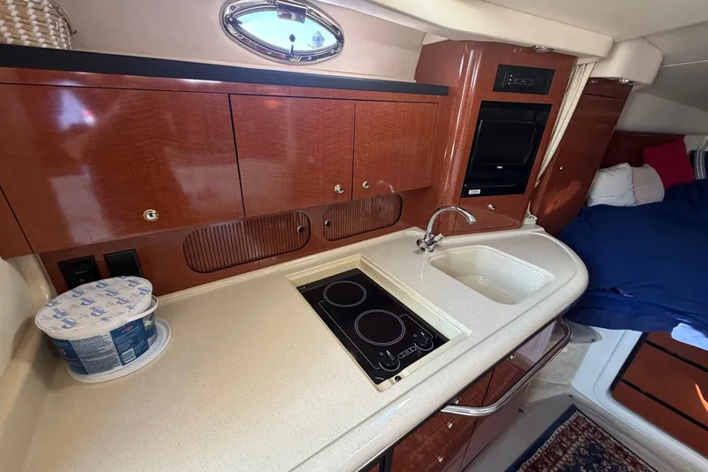 Slide: The Image of Interior of 2004 Sea Ray 340 Sundancer yacht with kitchenette and bed. - 13