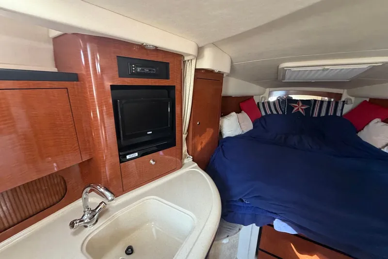 Slide: The Image of Interior of 2004 Sea Ray 340 Sundancer with bed, sink, and TV. - 15