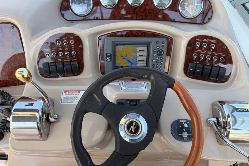 Slide: The Image of Dashboard of a 2004 Sea Ray 340 Sundancer boat with navigation controls. - 9