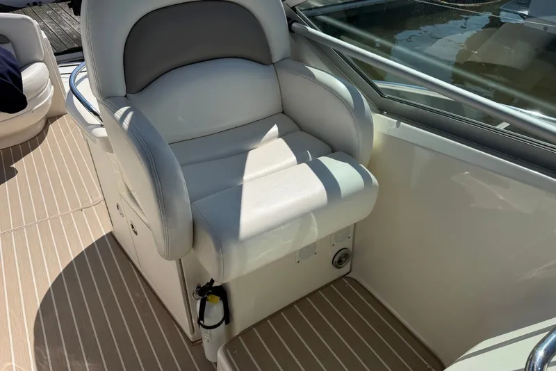 Slide: The Image of Captain's seat on 2004 Sea Ray 340 Sundancer boat, featuring white upholstery and sleek design. - 7