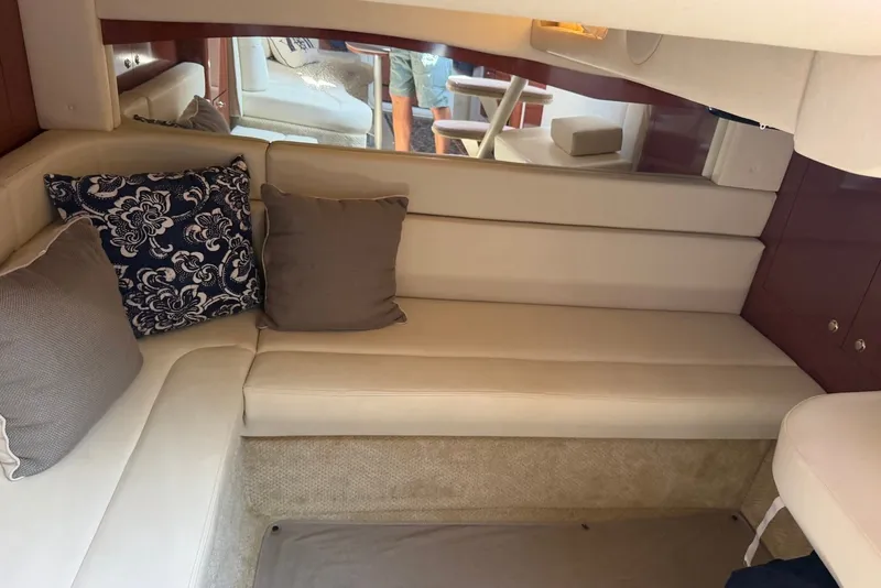 Slide: The Image of Interior of 2004 Sea Ray 340 Sundancer with beige seating and decorative pillows. - 27