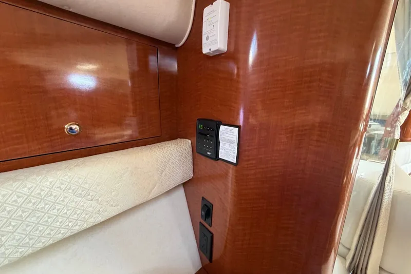 Slide: The Image of Interior of 2004 Sea Ray 340 Sundancer with wood paneling and control panel. - 28