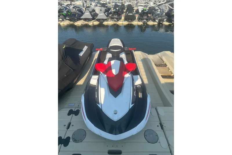 Slide: The Image of 2021 Yamaha WaveRunner VX Deluxe jet ski docked at marina. - 2