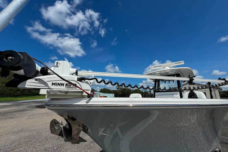 Slide: The Image of 2023 Sportsman Heritage 261 Center Console with Minn Kota Terrova motor under clear blue sky. - 68