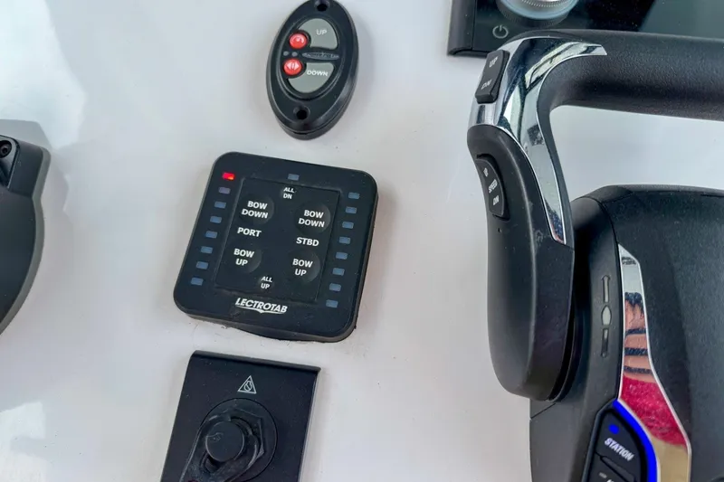 Slide: The Image of Control panel of 2023 Sportsman Heritage 261 Center Console boat with Lectrotab system. - 26
