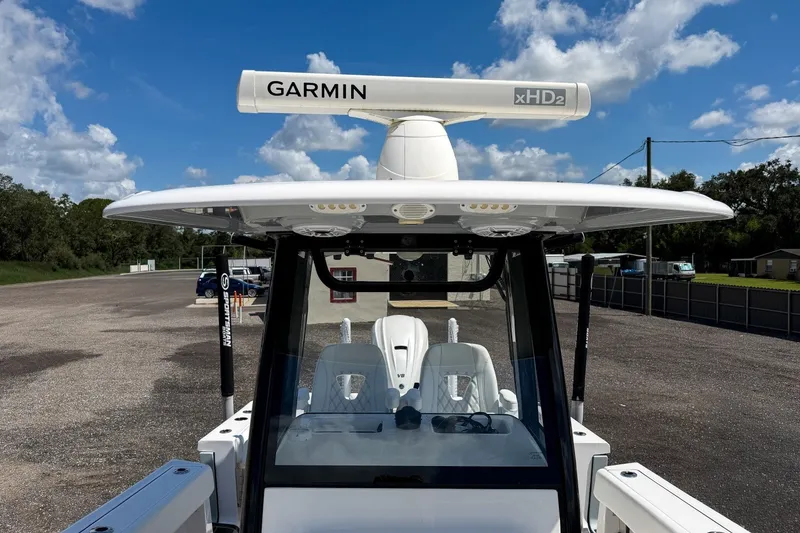 Slide: The Image of 2023 Sportsman Heritage 261 Center Console boat with Garmin xHD2 radar under clear blue sky. - 35