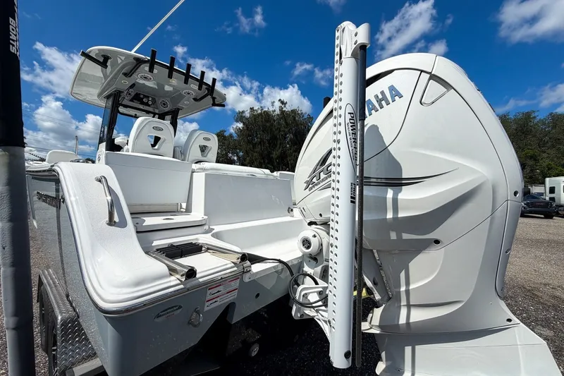 Slide: The Image of 2023 Sportsman Heritage 261 Center Console boat with Yamaha engine, parked outdoors. - 15