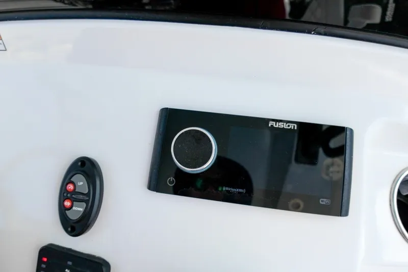 Slide: The Image of Control panel of 2023 Sportsman Heritage 261 Center Console boat with Fusion audio system. - 30