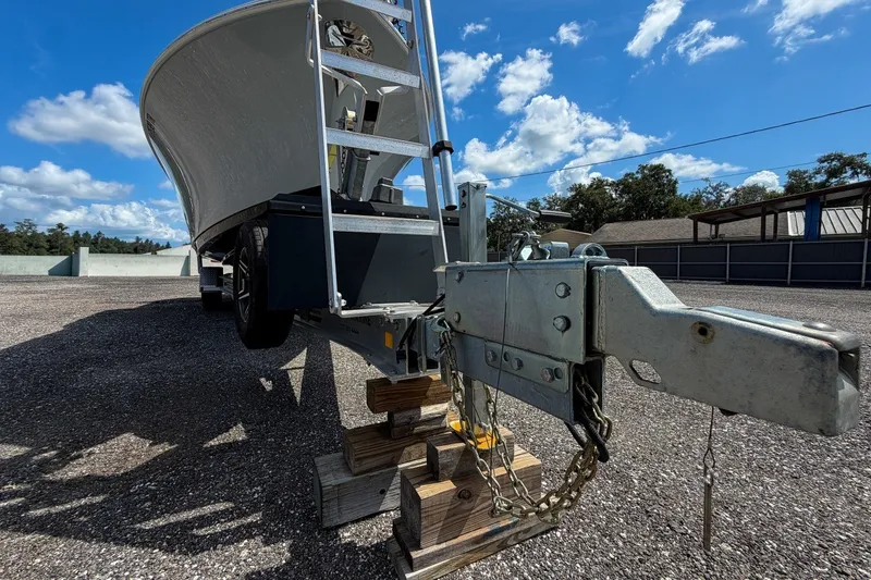 Slide: The Image of 2023 Sportsman Heritage 261 Center Console boat on trailer under clear blue sky. - 83
