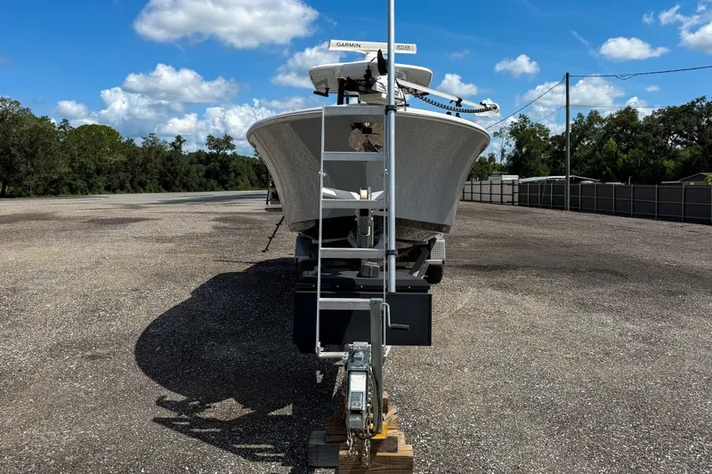 Slide: The Image of 2023 Sportsman Heritage 261 Center Console boat on trailer, parked outdoors under blue sky. - 9