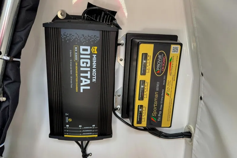 Slide: The Image of Minn Kota and Sportsman battery chargers on 2023 Heritage 261 Center Console boat. - 57