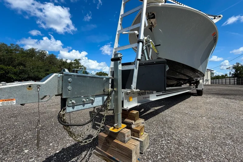 Slide: The Image of 2023 Sportsman Heritage 261 Center Console on trailer under clear blue sky. - 84