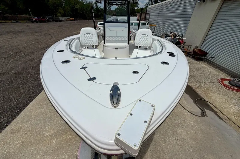 Slide: The Image of 2023 Sportsman Heritage 261 Center Console boat, white exterior, docked outdoors. - 65