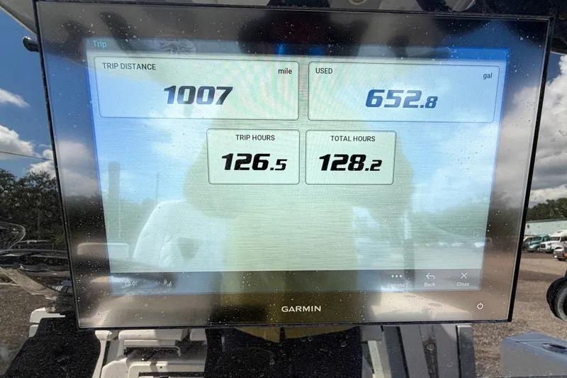 Slide: The Image of Garmin display showing trip data on 2023 Sportsman Heritage 261 Center Console boat. - 27