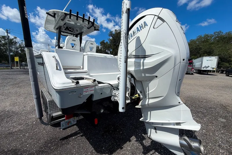 Slide: The Image of 2023 Sportsman Heritage 261 Center Console boat with Yamaha outboard motor, parked outdoors. - 14