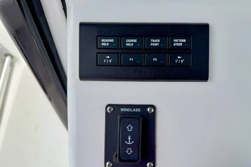 Slide: The Image of Control panel on 2023 Sportsman Heritage 261 Center Console boat, featuring Yamaha navigation and windlass controls. - 24