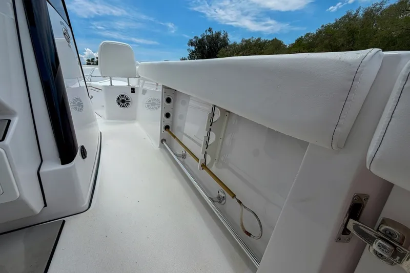 Slide: The Image of 2023 Sportsman Heritage 261 Center Console interior with white seating and storage compartments. - 50