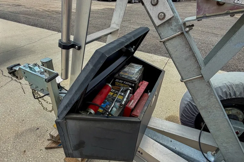 Slide: The Image of Open toolbox on trailer with various tools and accessories, near Sportsman Heritage 261 Center Console. - 88