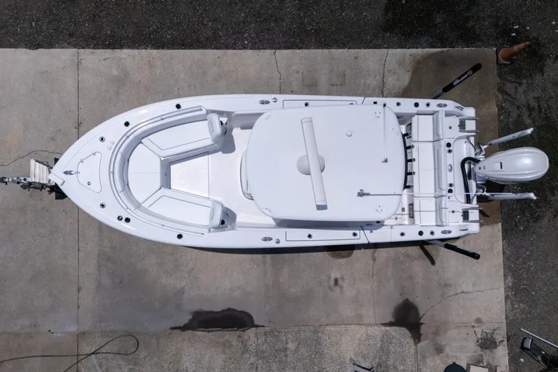 Slide: The Image of 2023 Sportsman Heritage 261 Center Console boat, aerial view, docked on concrete surface. - 3