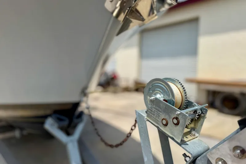 Slide: The Image of Close-up of a 2023 Sportsman Heritage 261 Center Console boat trailer winch. - 81