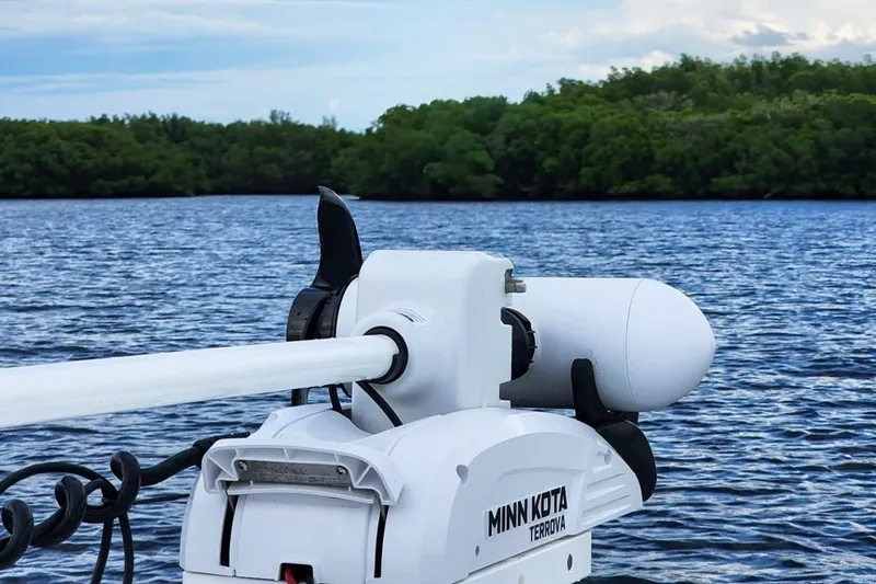 Slide: The Image of Minn Kota Terrova motor on 2023 Sportsman Heritage 261 Center Console, scenic water backdrop. - 71