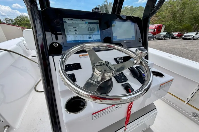 Slide: The Image of 2023 Sportsman Heritage 261 Center Console dashboard with steering wheel and digital displays. - 22