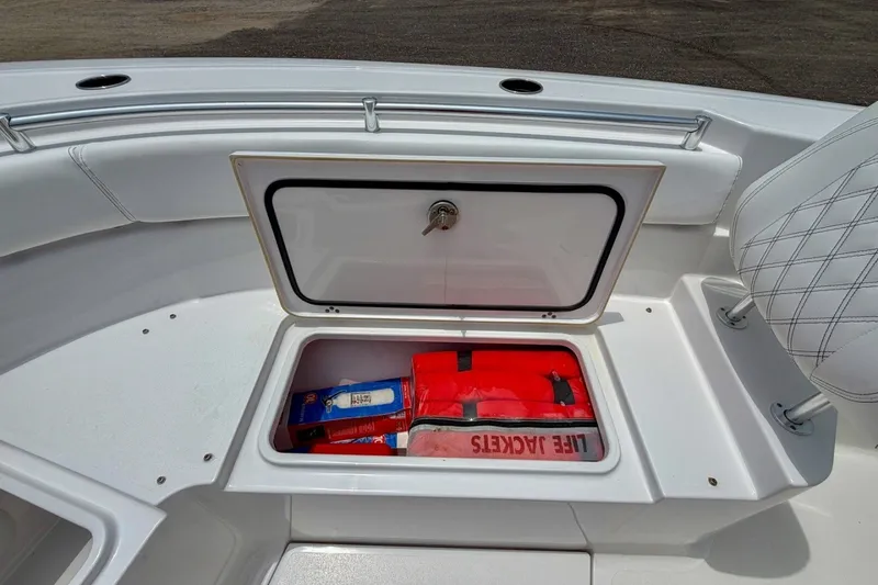 Slide: The Image of 2023 Sportsman Heritage 261 Center Console storage with life jackets and supplies. - 46