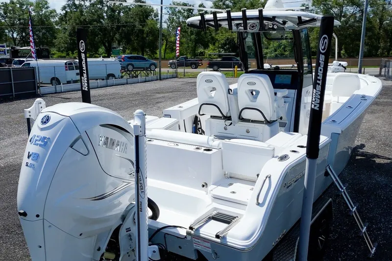 Slide: The Image of 2023 Sportsman Heritage 261 Center Console boat with Yamaha V8 engine, displayed outdoors. - 4