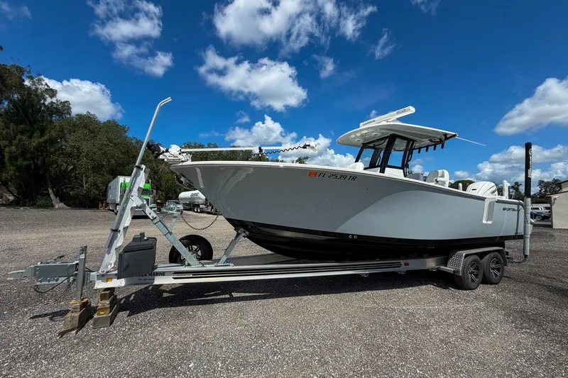 Slide: The Image of 2023 Sportsman Heritage 261 Center Console boat on trailer under blue sky. - 10