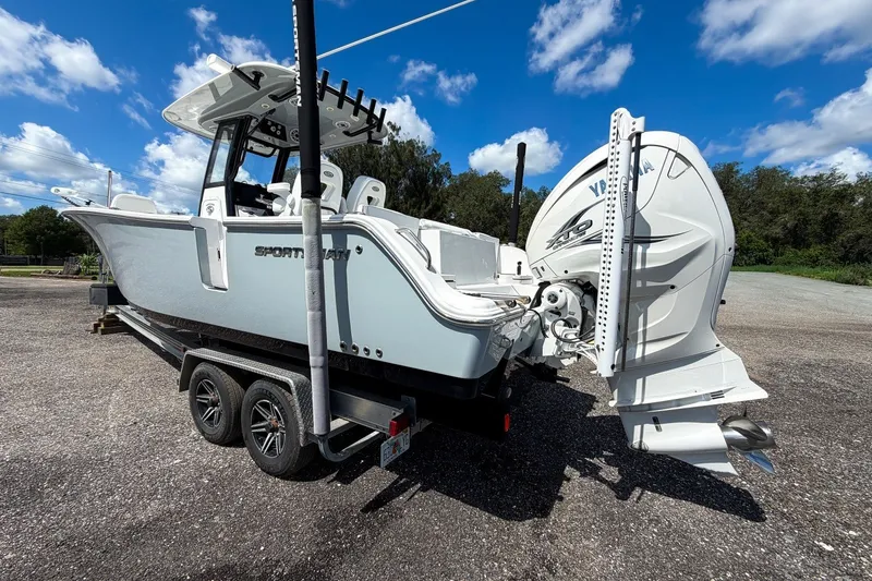 Slide: The Image of 2023 Sportsman Heritage 261 Center Console boat on trailer, parked outdoors. - 13