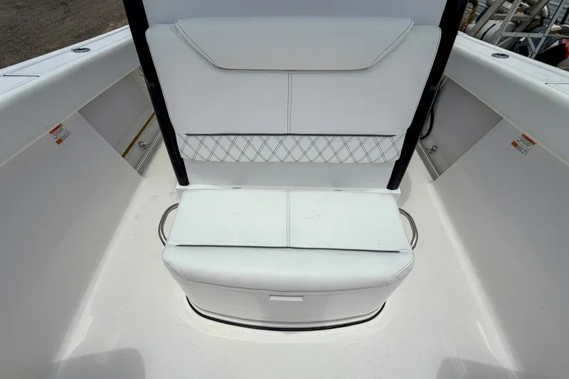 Slide: The Image of 2023 Sportsman Heritage 261 Center Console boat seating area, featuring white cushioned seats. - 36