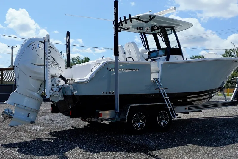 Slide: The Image of 2023 Sportsman Heritage 261 Center Console boat on trailer, featuring dual engines. - 5