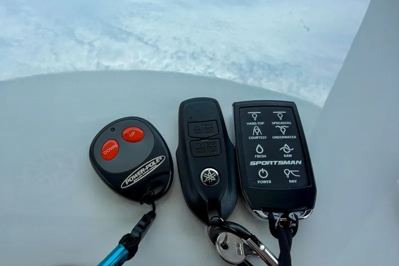 Slide: The Image of Remote controls for 2023 Sportsman Heritage 261 Center Console boat, featuring Power-Pole and Yamaha keys. - 31