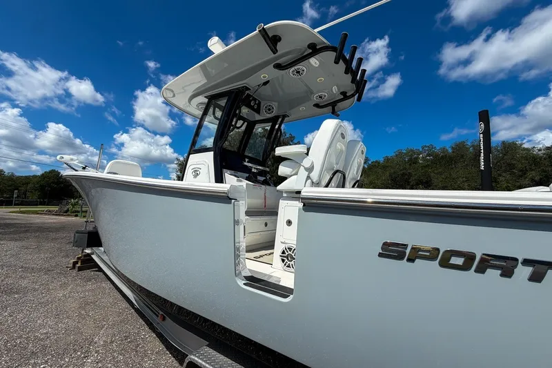 Slide: The Image of 2023 Sportsman Heritage 261 Center Console boat under a clear blue sky. - 12