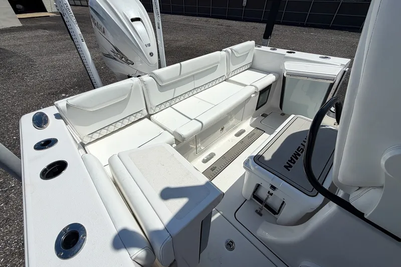 Slide: The Image of 2023 Sportsman Heritage 261 Center Console boat interior with white seating and Yamaha engine. - 58