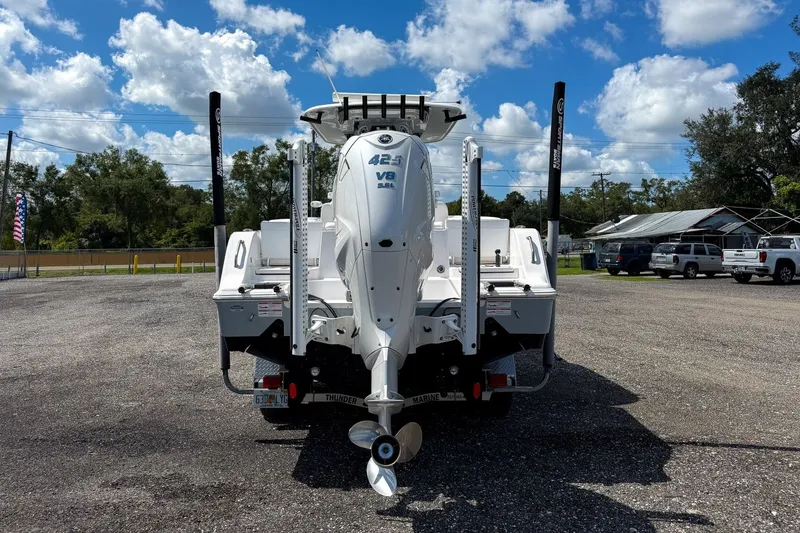 Slide: The Image of 2023 Sportsman Heritage 261 Center Console boat with powerful V8 engine, parked outdoors. - 17