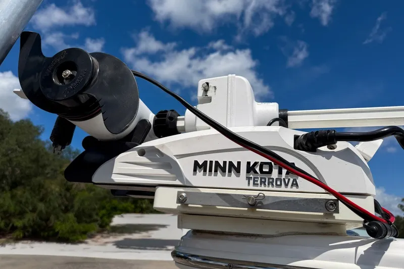 Slide: The Image of Minn Kota Terrova motor on 2023 Sportsman Heritage 261 Center Console boat under blue sky. - 70