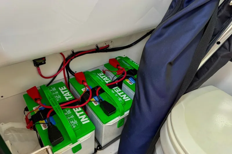 Slide: The Image of Batteries in a 2023 Sportsman Heritage 261 Center Console boat, neatly arranged and connected. - 56