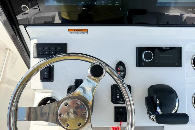 Slide: The Image of 2023 Sportsman Heritage 261 Center Console dashboard with steering wheel and controls. - 23
