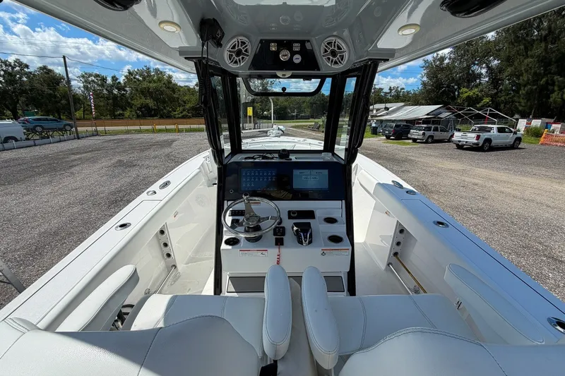 Slide: The Image of 2023 Sportsman Heritage 261 Center Console boat interior with modern dashboard and seating. - 20