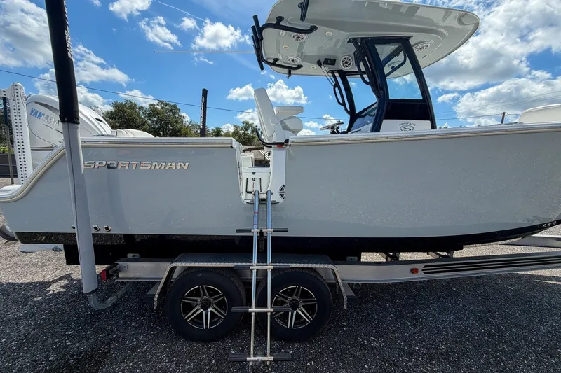 Slide: The Image of 2023 Sportsman Heritage 261 Center Console boat on trailer under blue sky. - 6
