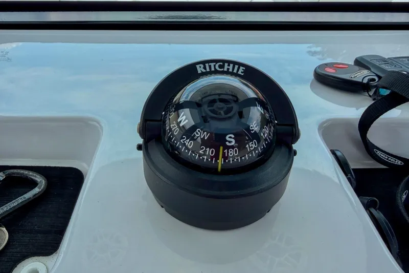 Slide: The Image of Compass on 2023 Sportsman Heritage 261 Center Console boat dashboard. - 32