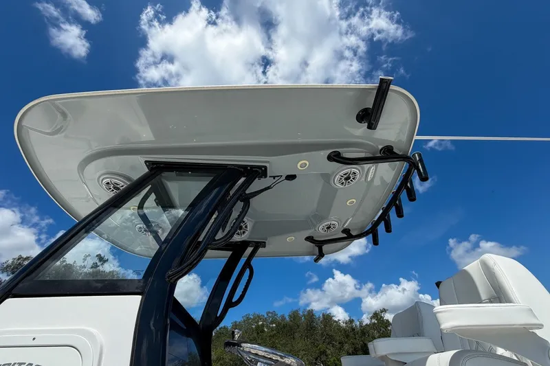 Slide: The Image of 2023 Sportsman Heritage 261 Center Console boat with T-top against blue sky. - 18