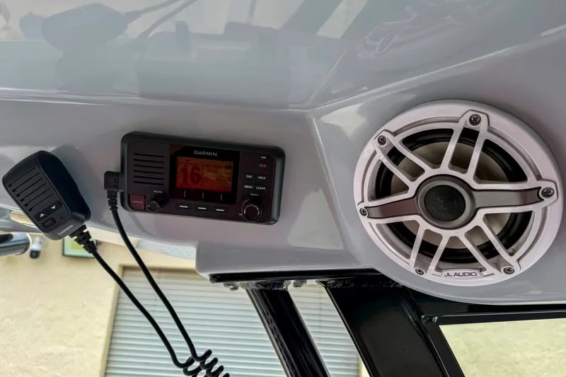 Slide: The Image of Garmin radio and JL Audio speaker on 2023 Sportsman Heritage 261 Center Console boat. - 34
